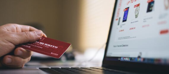 person holding a credit card for online shopping