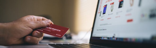 person holding a credit card for online shopping