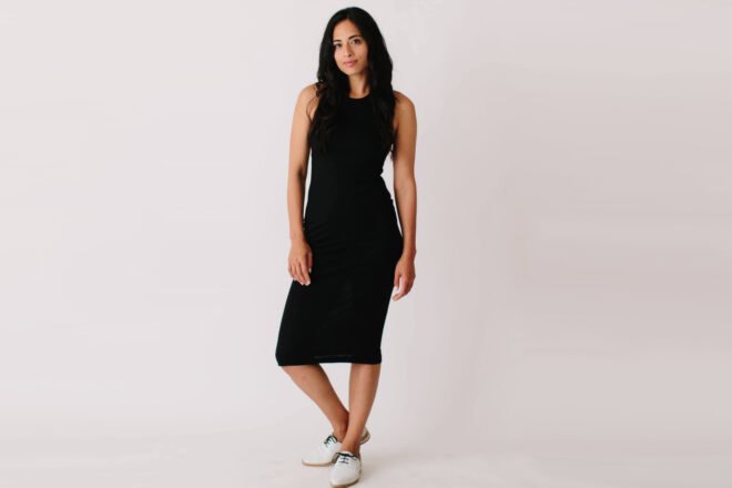 model wearing mid-length black dress
