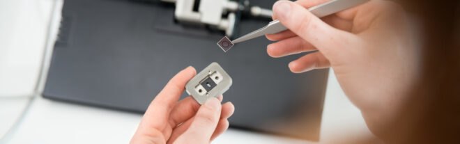 person assembles and installs a chip into a sensor