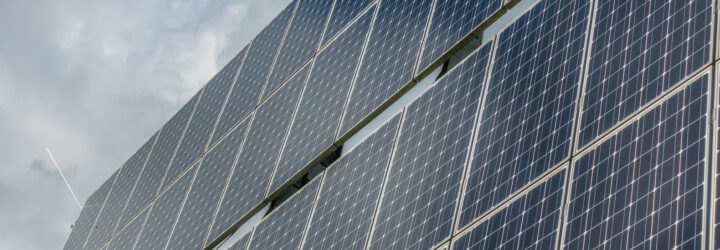 solar panels with blue cloudy sky in background