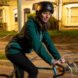 person wearing teal jacket and helmet while riding a bike