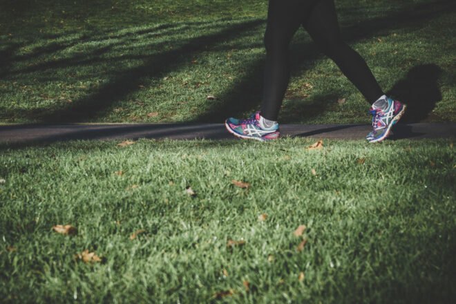 person walking briskly in city park