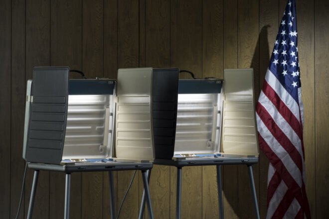 voting booths beside American flag