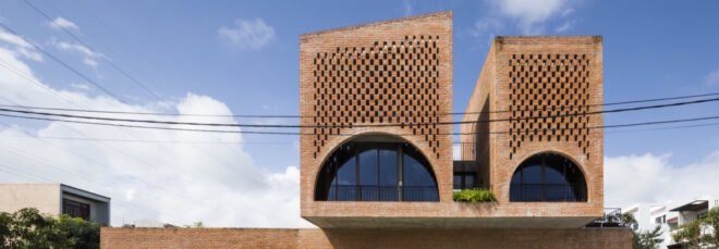 linear brick home with two additional brick volumes on second story