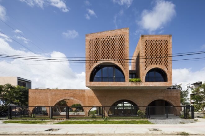 linear brick home with two additional brick volumes on second story