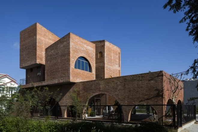 linear brick home with two additional brick volumes on second story