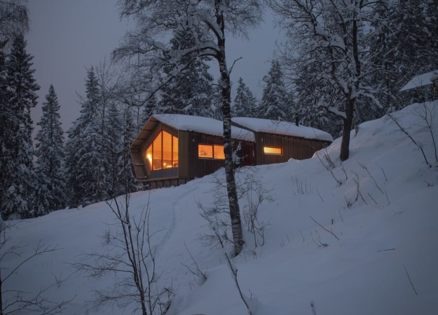 wood cabin covered in snow