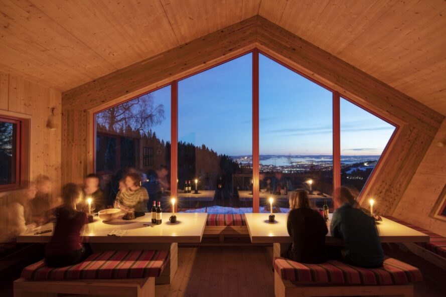 diners eating candlelit dinners near large window