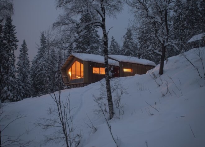 wood cabin covered in snow