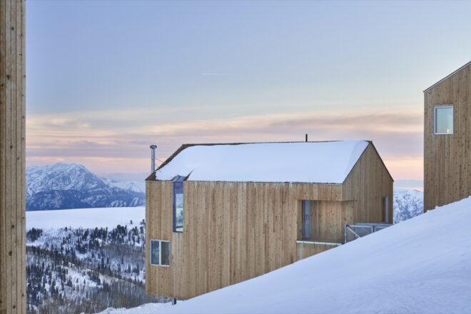 timber ski cabin surrounded by snow