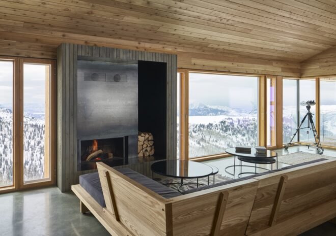 interior of wooden cabin with wood ceiling and large windows