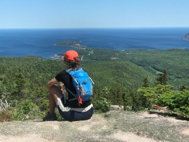 person sitting looking out over views of ocean