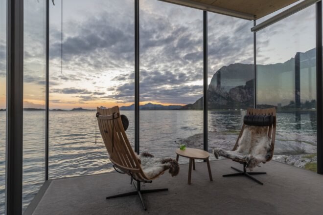 two wood chairs in room with glass walls