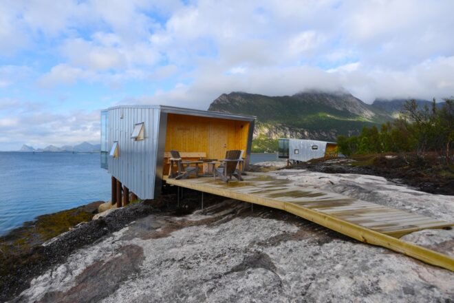 wood walkway leading to aluminum cabin