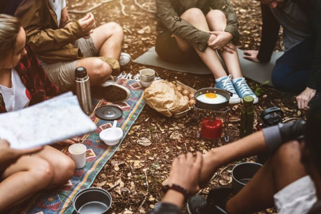 people camping and preparing food