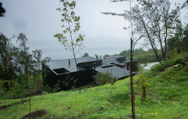 black home facing a lake