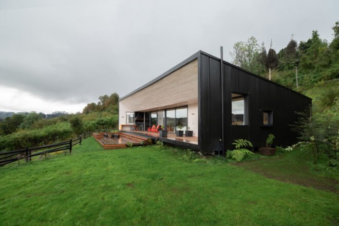 dark home with light wood porch
