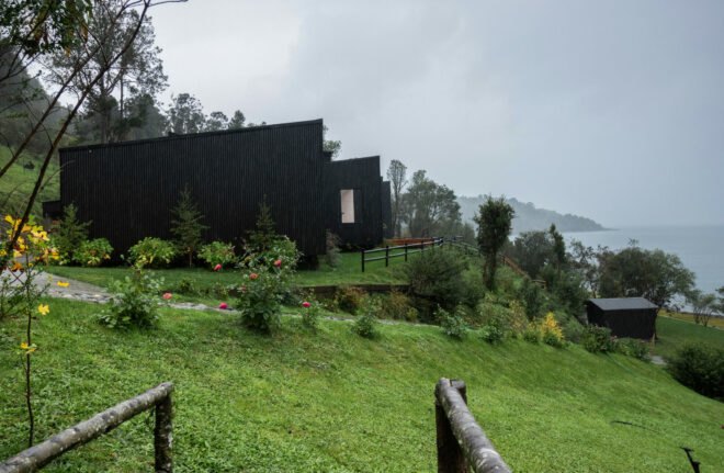 long black home near a lake
