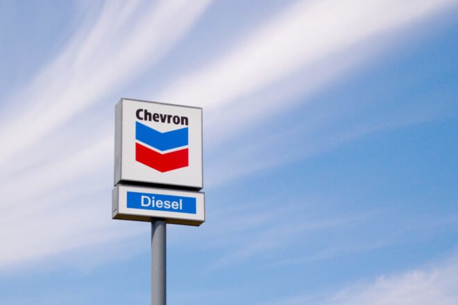 Chevron gas station sign against blue skies