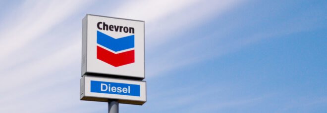Chevron gas station sign against blue skies