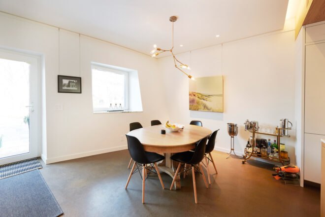 dining area with wood table under gold chandelier