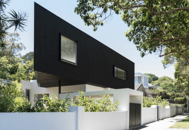 home with white lower floor and black upper floor