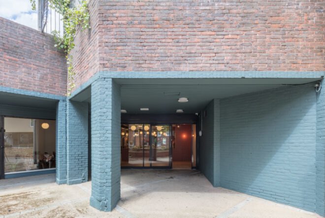brick exterior with some bricks painted light blue