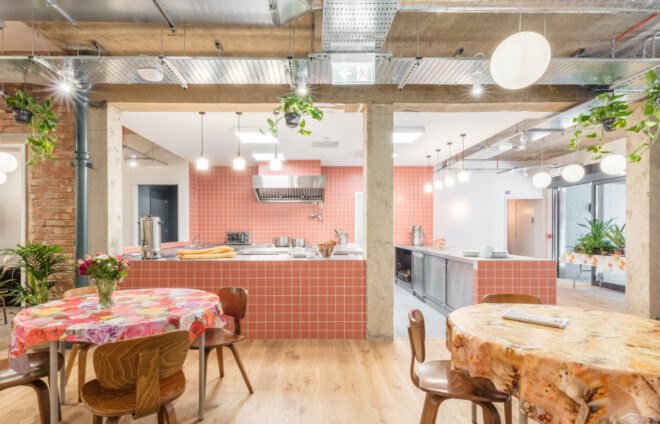 open kitchen and round tables with patterned tablecloths