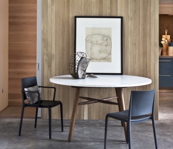 small white dining table with two black chairs