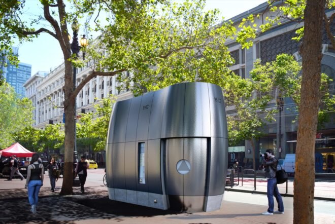 small curved metal bathroom unit in a city