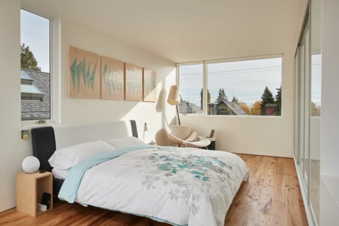 all white bedroom with large window