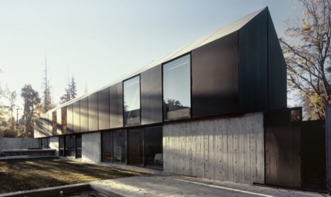 elongated black home with gabled roof