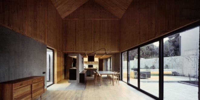 wood-lined interior with long white dining table