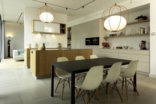 dining area with black table and white chairs