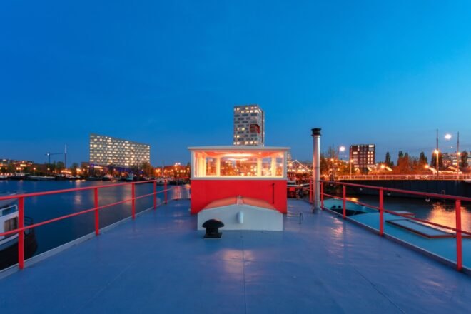 red exterior of room atop a houseboat