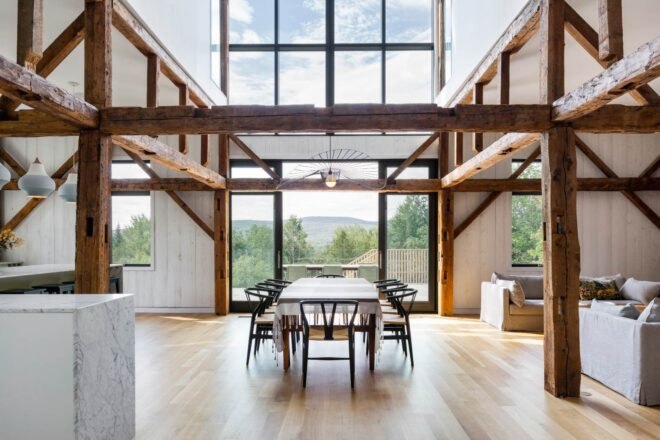 large interior space with dining table and glass facades
