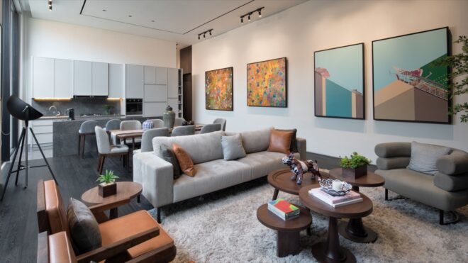 living area with gray sofa and small round wood coffee tables