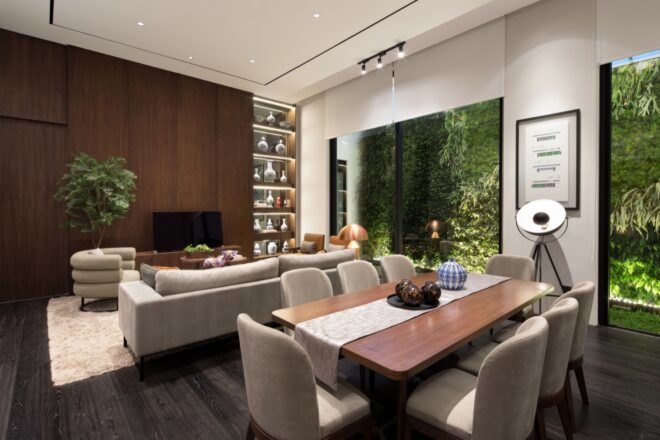 open-plan living and dining area with wood dining table and gray sofa