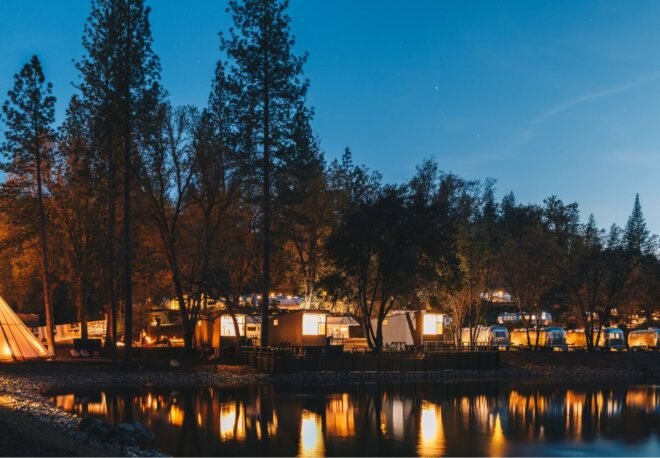 group of black cabins on waters edge