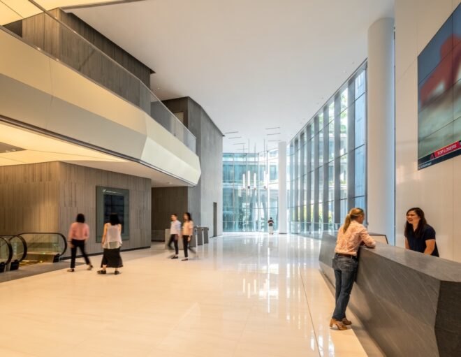 people inside white and gray room with large windows