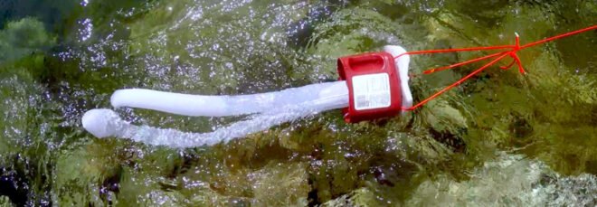 ocean trawl made from old container and leggings filtering water in an ocean