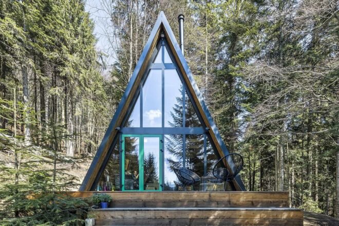 dark A-frame cabin in the woods