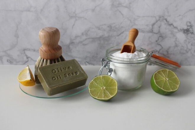 natural soaps and cleaning powders on white table