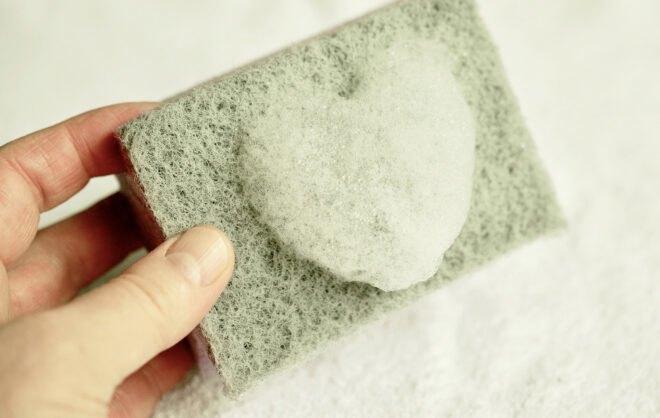 green sponge with foamy soap in the shape of a heart