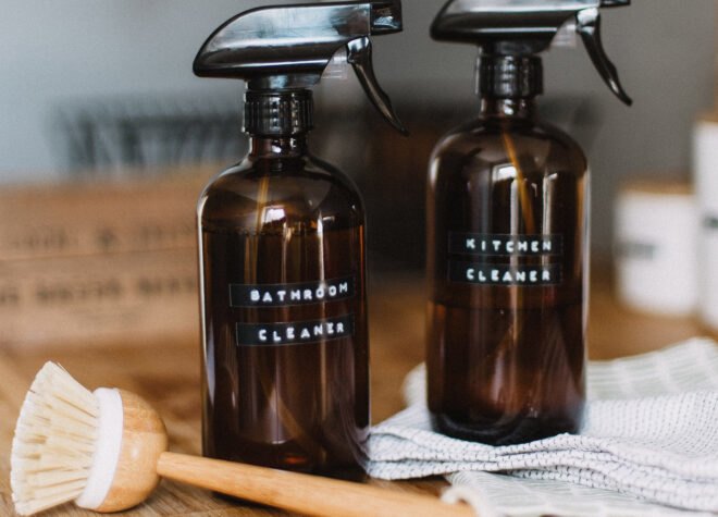 brown amber bottles labeled "Kitchen Cleaner" and "Bathroom Cleaner"