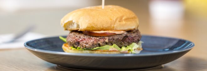 Impossible brand Burger on a blue plate
