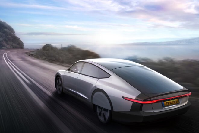 silver electric car driving on curvy road