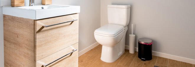 bathroom with toilet and wood cabinet