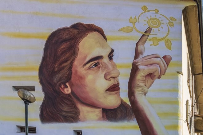 painting of girl touching symbols for clean energy